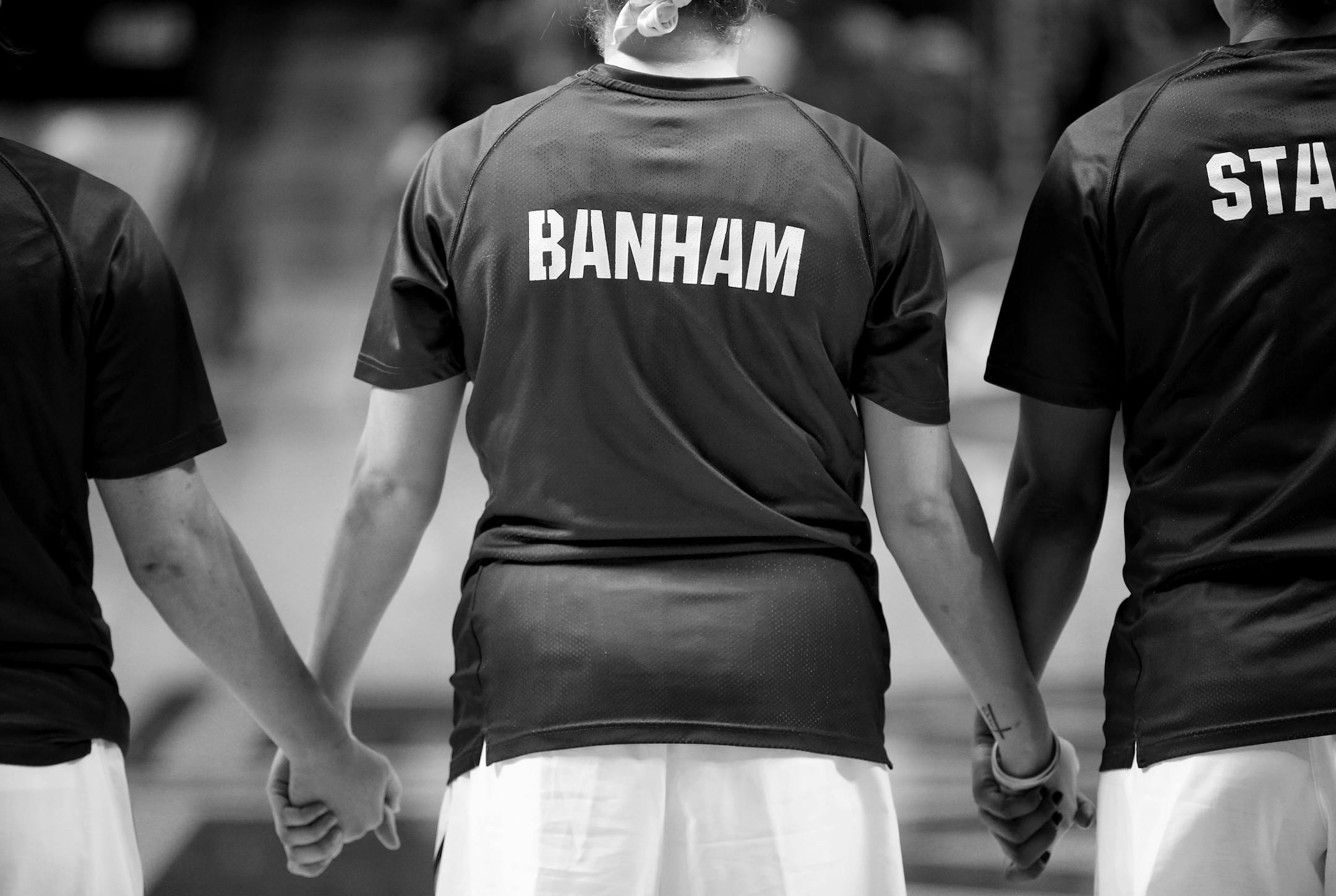 Rachel Banham held hands with teammates during the National Anthem at Williams Arena before a game vs. Nebraska.
