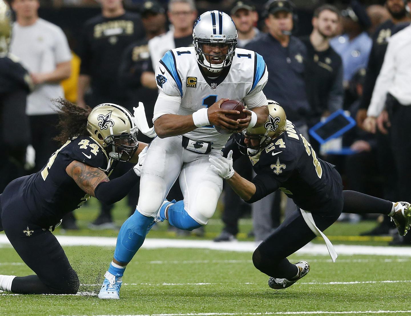 Carolina Panthers quarterback Cam Newton (1) tries to avoid the tackle by New Orleans Saints outside linebacker Hau'oli Kikaha (44) and cornerback Sterling Moore (24) in the second half of an NFL football game in New Orleans, Sunday, Dec. 3, 2017. The Saints won 31-21. (AP Photo/Butch Dill) ORG XMIT: NYOTK