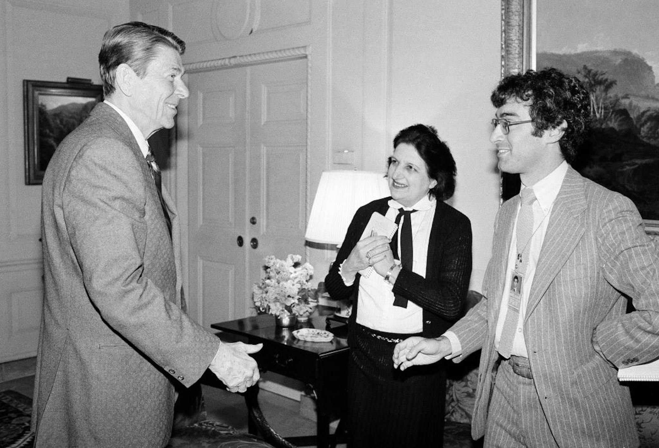 FILE - In this April 13, 1981, file photo, President Ronald Reagan greets UPI reporter Helen Thomas, center, and AP reporter Jim Gerstenzang, right, before an interview in the Treaty Room of the White House in Washington. Thomas, a pioneer for women in journalism and an irrepressible White House correspondent, has died Saturday, July 20, 2013. She was 92.