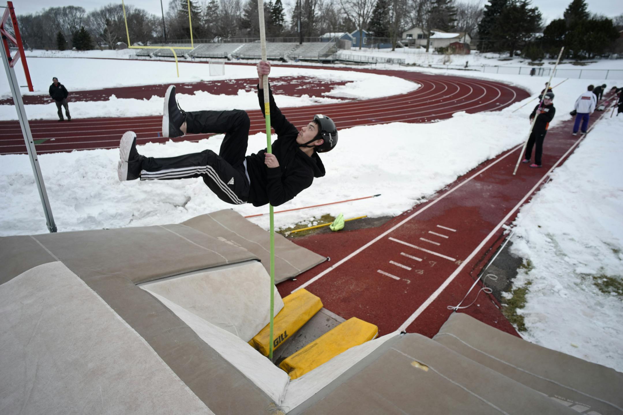 Pole vaulter Sam Adair of White Bear Lake's track and field team takes to the air Wednesday on the first day the team has been able to practice outside at the school.