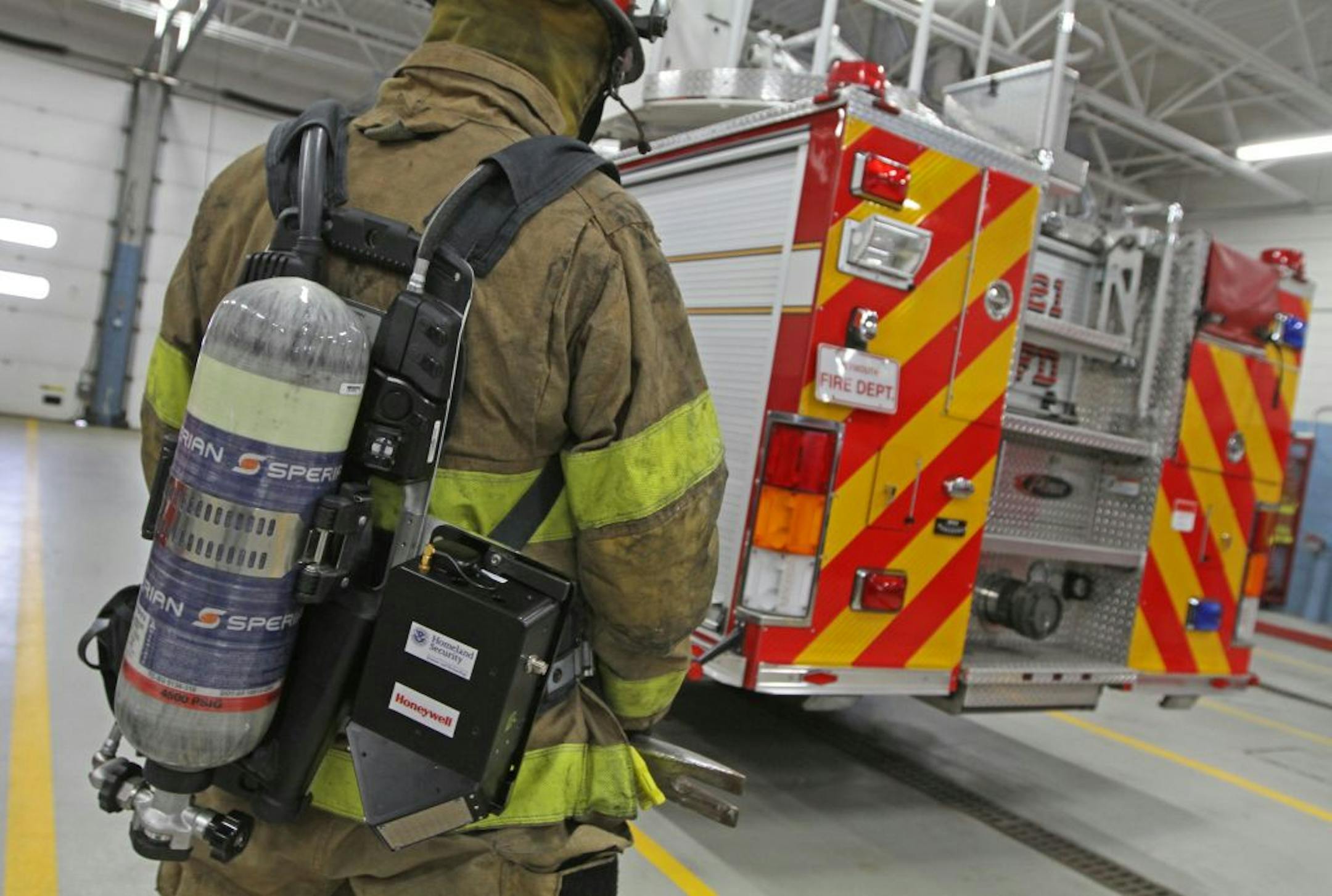 Plymouth Fire Captain Tom Evenson wore a transmitter (black box next to his air bottle) that gives the location of fire fighters inside a burning building as they fight a fire, as part of a tracking system developed by Honeywell. The Plymouth Fire Dept. helped Honeywell test and refine the device, which can pinpoint the exact location of a firefighter (to within 36 inches) when inside of a burning building. System does not use GPS. GPS doesn't work inside thick concrete buildings.