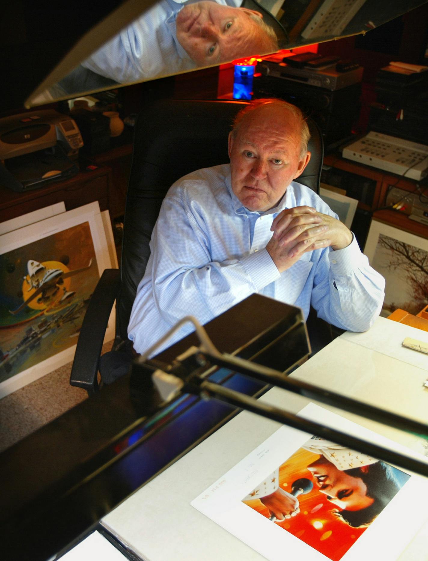 Minnetonka, MN 11/27/2002 John Berkey is a local artist who has done several paintings for the post office that have become stamps. He's done everything from a California Gold Rush stamp, to Otis Redding, to Elvis to Santa. Berkey in his Minnetonka home studio.