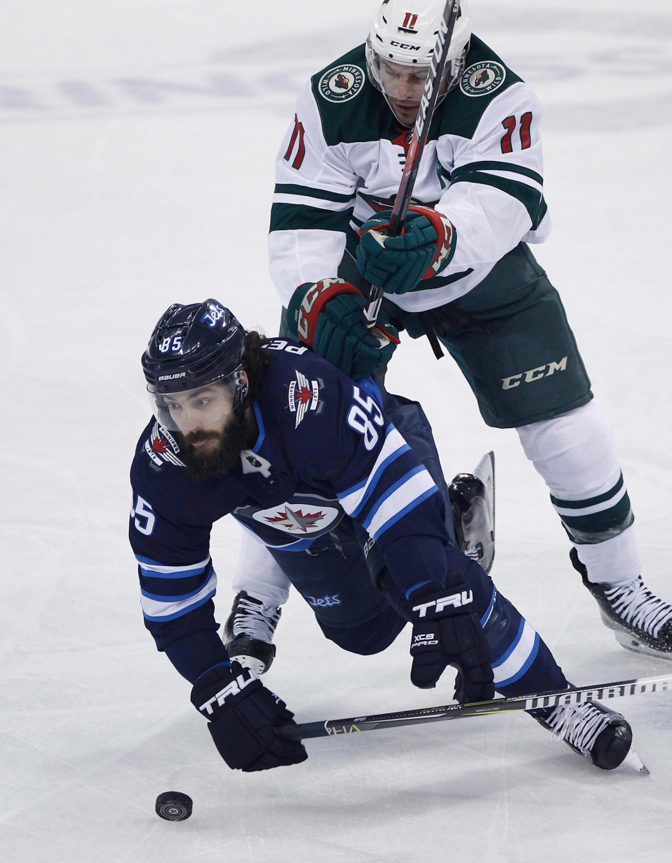 Winnipeg Jets' Mathieu Perreault (85) is checked by Minnesota Wild's Zach Parise (11) during the first period of Game 1 in an NHL hockey first-round playoff series Wednesday, April 11, 2018, in Winnipeg, Manitoba.