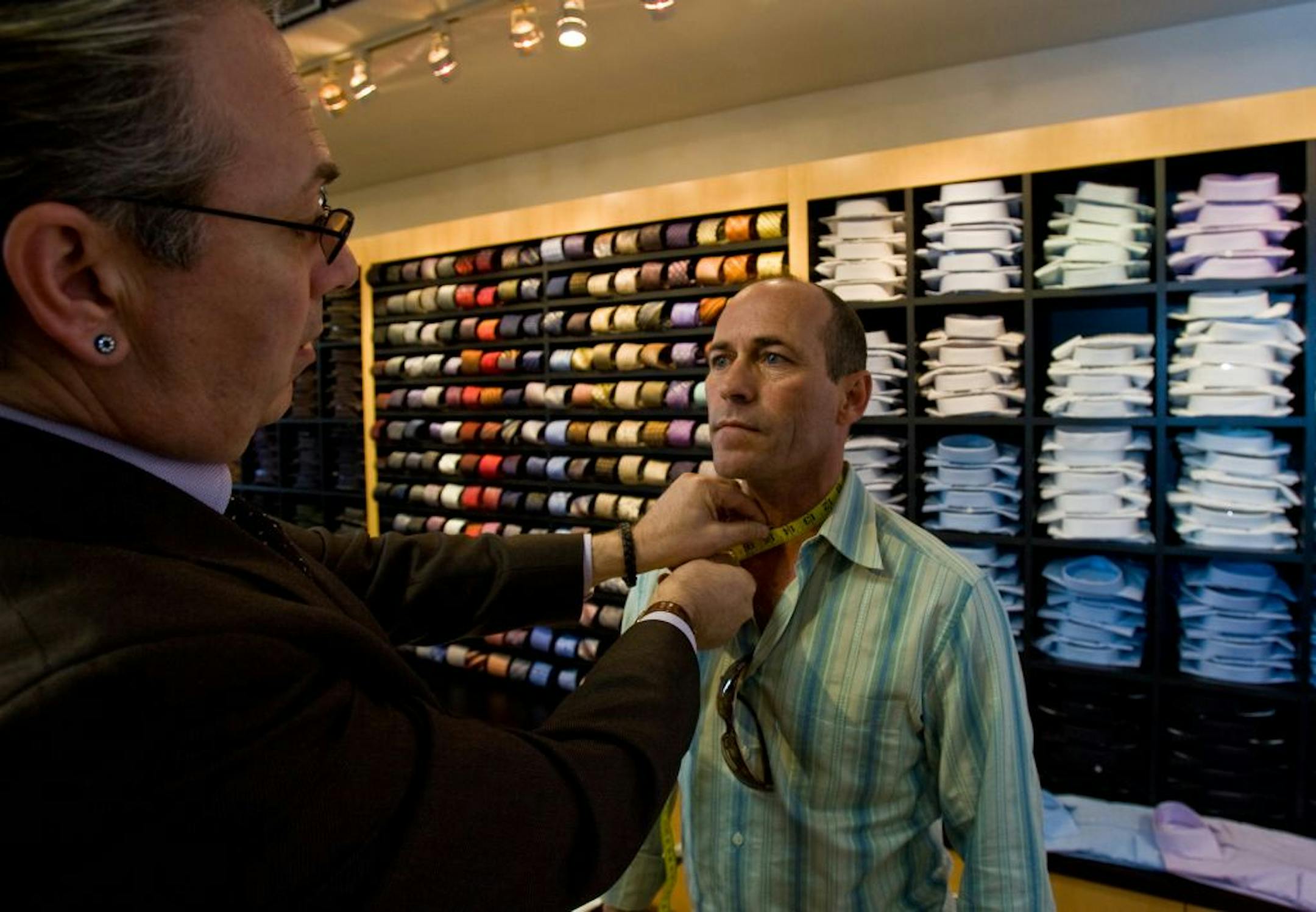 Manager Fred Gutierrez checks the collar size of Hall of Fame jockey Gary Stevens, who was stocking up on dress shirts at Jimmy Au's for Men 5'8" and Under in Beverly Hills, Calif.