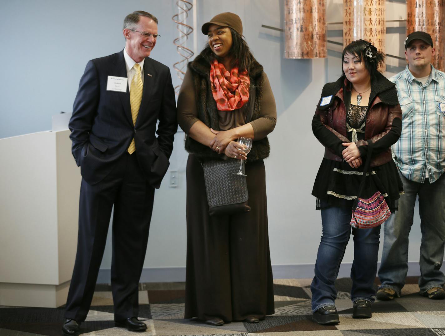 Richard Davis left talked with artist Ericka Dennis during a reception for the new Habitat for Humanity's building .Profile on Richard Davis CEO of US. Bank , he spoke at a reception at the Habitat for Humanity's new building Tuesday May 6, 2014 in St. Paul, MN. ] Jerry Holt Jerry.holt@startribune.com