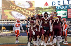 Minnesota quarterback Athan Kaliakmanis (8) reacted after the Gophers scored against Syracuse in the Pinstripe Bowl game with Syracuse that ended the 