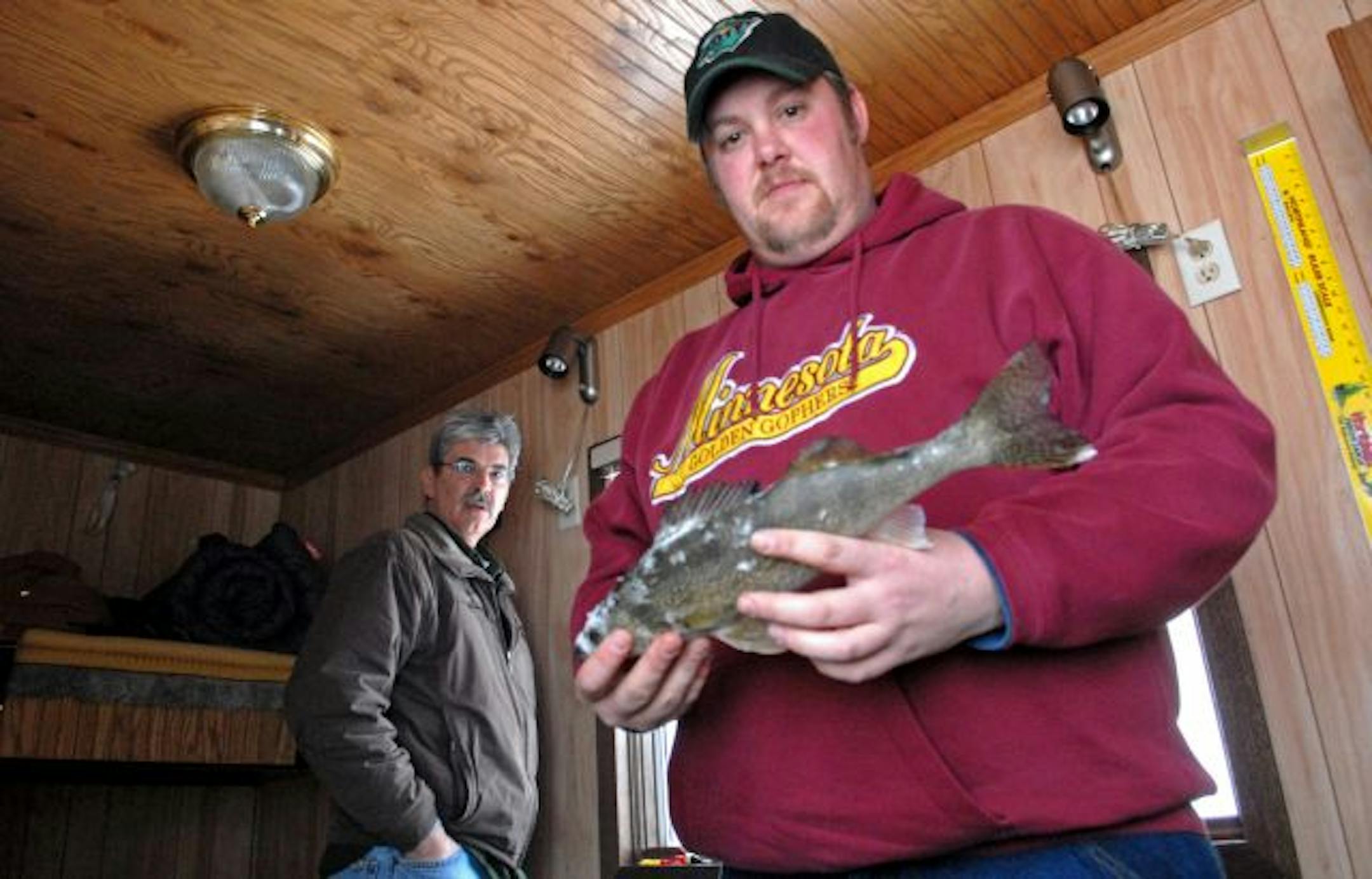 Two anglers renting a Upper Red Lake fish house for a getaway from their homes in west-central Minnesota showed off one of their nice walleyes. On Upper Red Lake, walleyes under 17 inches can be kept.