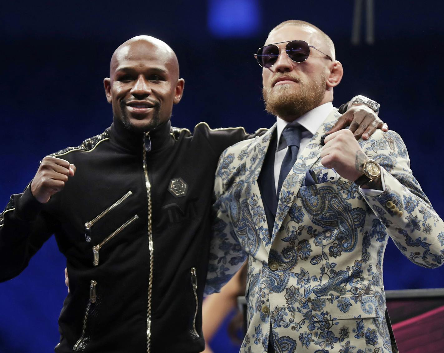 Floyd Mayweather Jr., left, and Conor McGregor pose during a news conference after a super welterweight boxing match Sunday, Aug. 27, 2017, in Las Vegas. (AP Photo/Isaac Brekken)