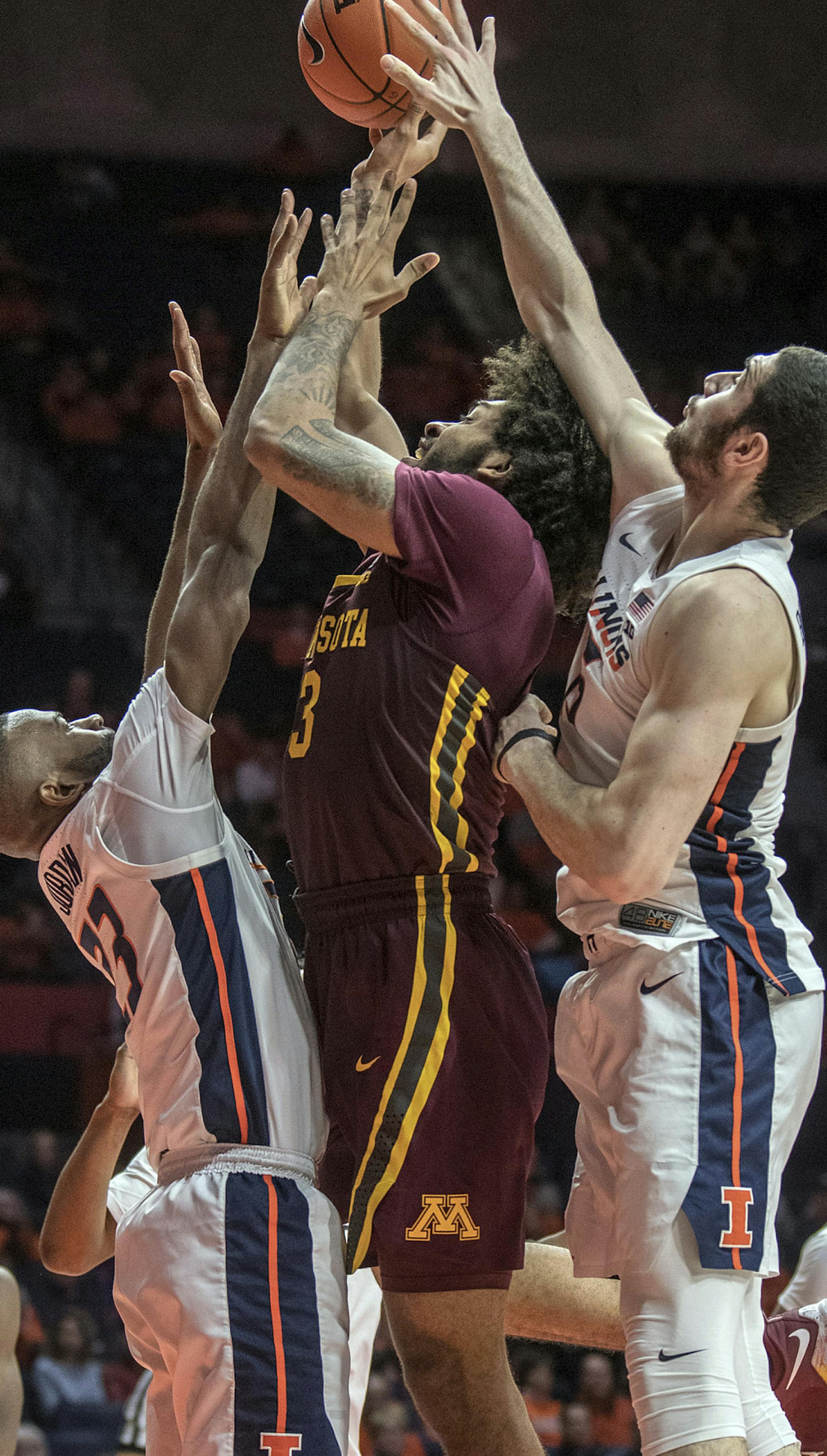 Minnesota forward Jordan Murphy (3) tries to shoot between Illinois guard Aaron Jordan, left, and forward Giorgi Bezhanishvili (15) during the second half of an NCAA college basketball game in Champaign, Ill., Wednesday, Jan. 16, 2019. (AP Photo/Rick Danzl)