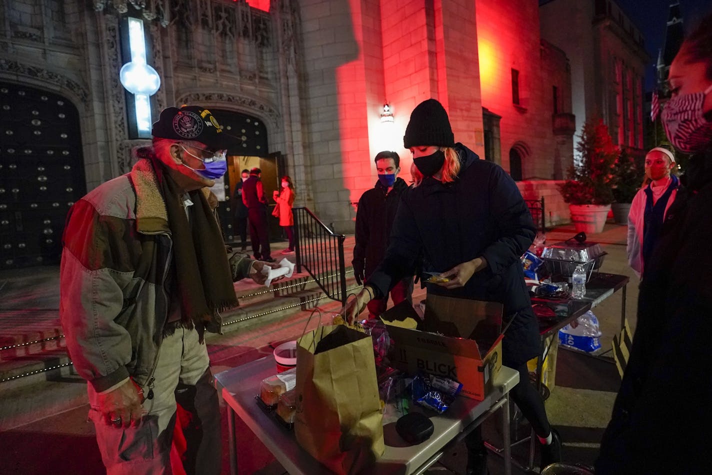 A group of volunteers from Ithaca, N.Y., hand out free cookies to voters in Scranton, Pa., on Election Day, Tuesday, Nov. 3, 2020. A single voting machine jammed for just minutes Tuesday morning at a precinct in Scranton, Joe Biden's hometown, but misleading posts on Facebook and Twitter claimed multiple machines there were down for hours.