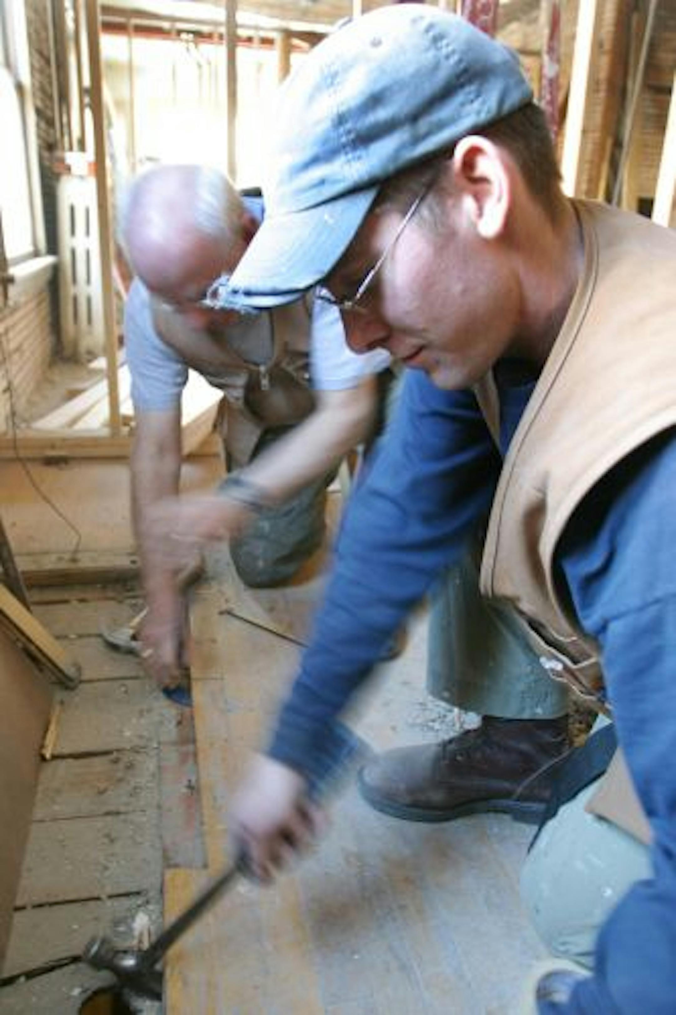 Dan Hunt, right, of Urban Homeworks worked to rehab a Minneapolis home with volunteer Dave Young in 2003. The nonprofit often "takes chances on people" it helps, Hunt says.