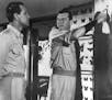 Route of Attack - William Holden (left), as a former American seaman who escaped from a Japanese prison camp, consults with Jack Hawkins, playing a Br