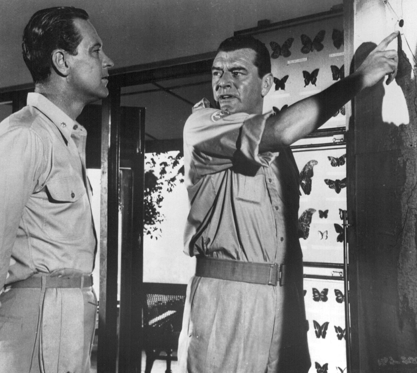 Route of Attack - William Holden (left), as a former American seaman who escaped from a Japanese prison camp, consults with Jack Hawkins, playing a British officer, about a route which will lead them to their objective, in "The Bridge on the River Kwai", a special two-part presentation on "The CBS Sunday Night Movies" Sunday, Jan. 16 (8:00-9:30 pm, EST) and Sunday, Jan, 23 (7:30-9:30 pm, EST) on the CBS Television Networks. (Rebroadcast). CBS