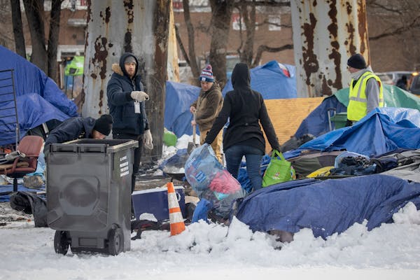 City organizations that aid the homeless showed up Tuesday to help take down an encampment at NE. 13th Avenue and Water Street in Minneapolis.