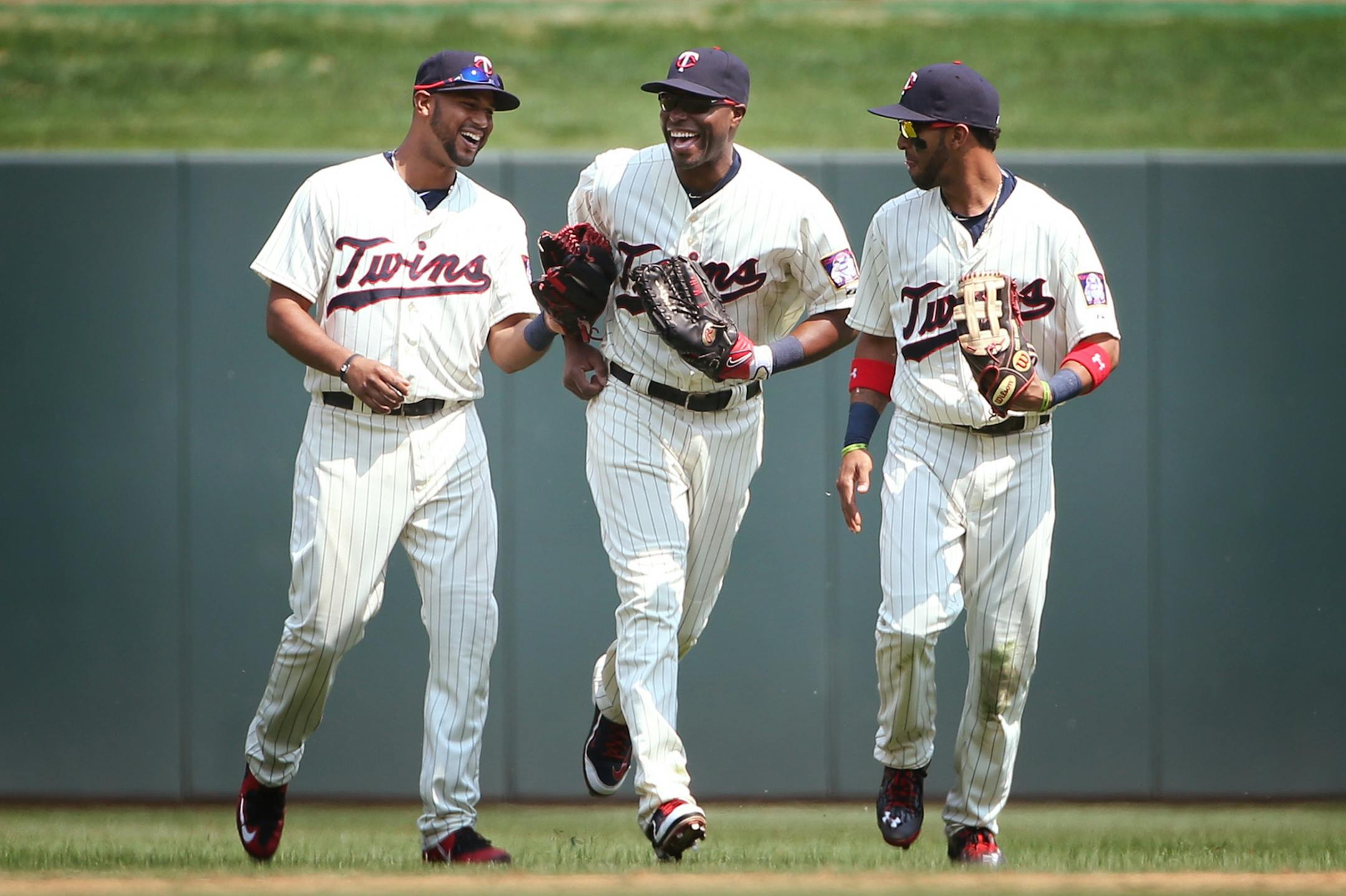 Minnesota Twins center fielder Aaron Hicks (32), from left, Minnesota Twins right fielder Torii Hunter (48) and Minnesota Twins left fielder Eddie Rosario (20) celebrate their 6-4 win at Target Field in Minneapolis on Wednesday, May 27, 2015.