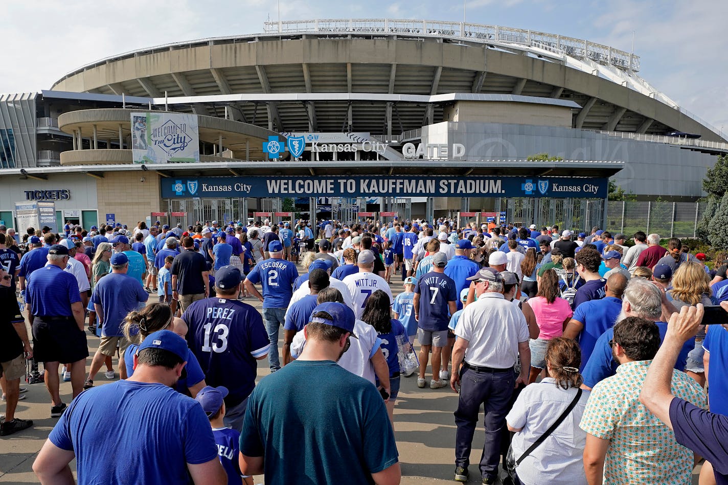 People line up to enter Kauffman Stadium before a baseball game between the Kansas City Royals and the Detroit Tigers Monday, July 17, 2023, in Kansas City, Mo. (AP Photo/Charlie Riedel)