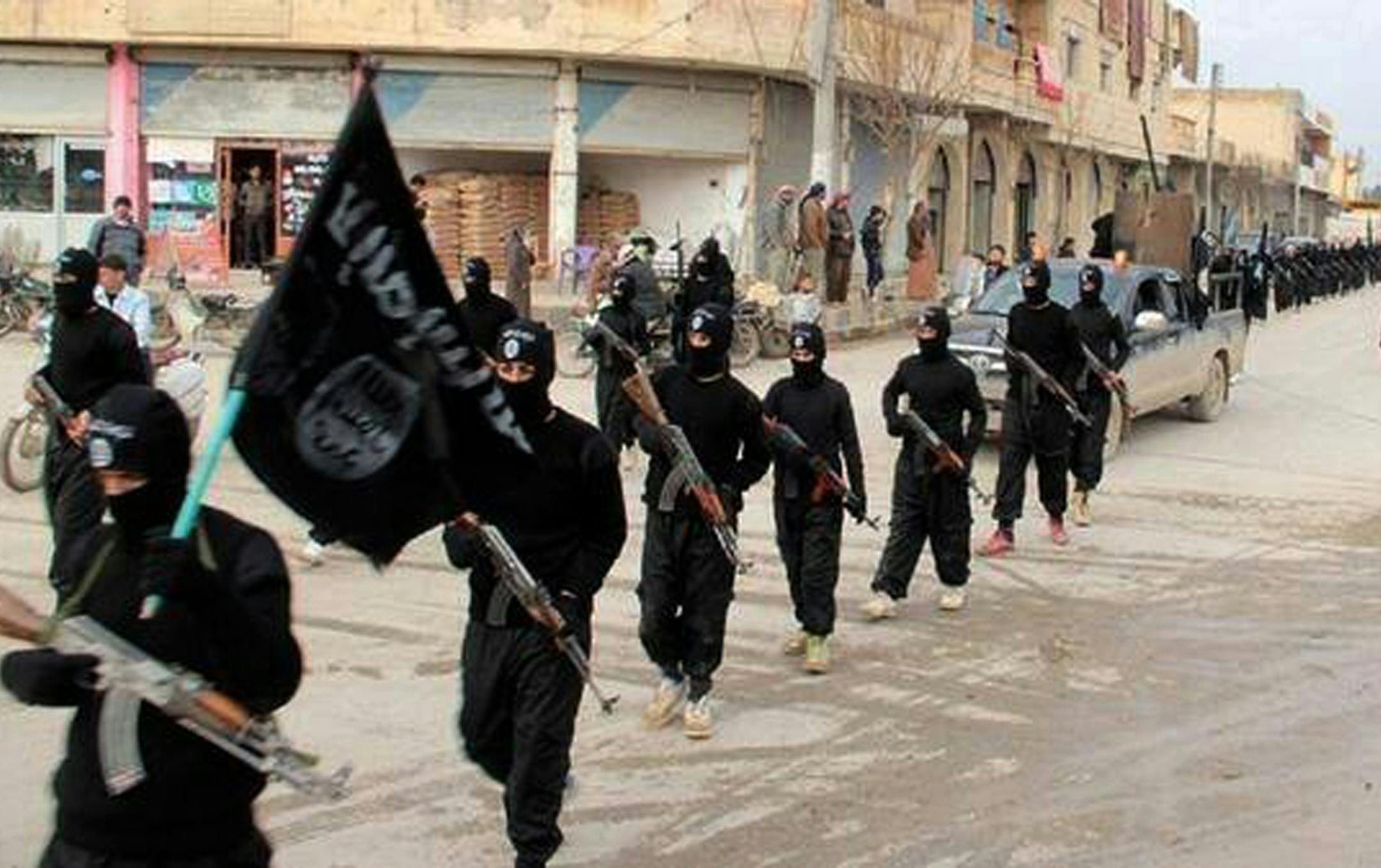 FILE - This undated file image posted on a militant website on Tuesday, Jan. 14, 2014, which has been verified and is consistent with other AP reporting, shows fighters from the al-Qaida linked Islamic State of Iraq and the Levant (ISIL), now called the Islamic State group, marching in Raqqa, Syria. When Islamic State fighters routed Syrian government forces and took control of the ruins of Palmyra Thursday, May 21, 2015 morning, the ancient city became the latest archaeological heritage site to