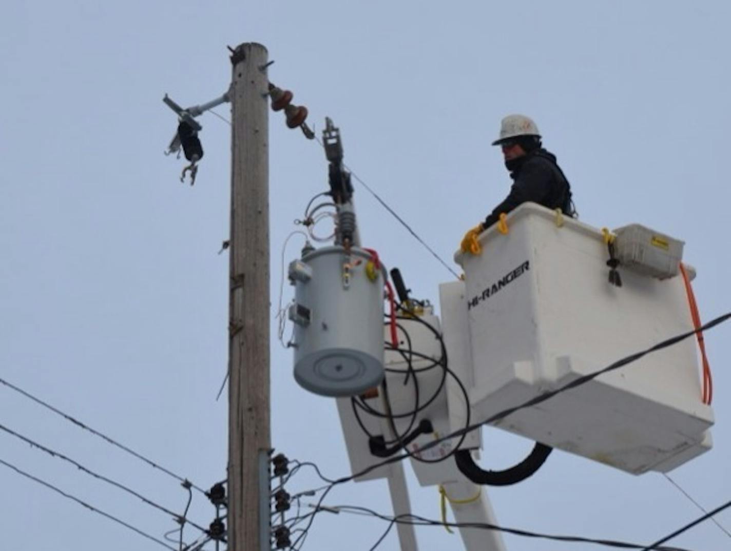 An electrical worker replaces parts in an alley on 23rd Ave. S., restoring power after more than 12 hours to a block in the Standish-Ericsson neighborhood of south Minneapolis.