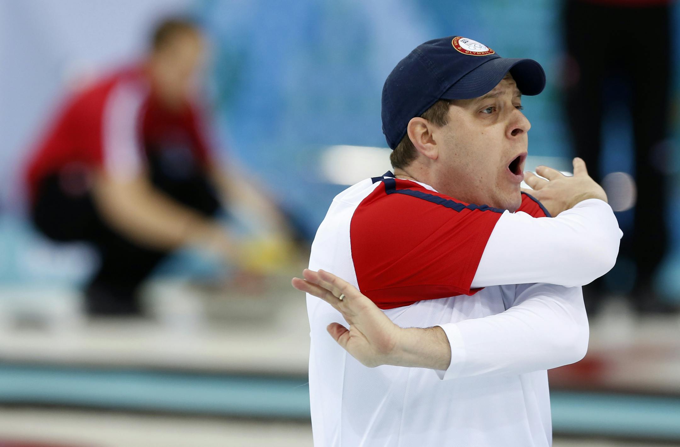 John Shuster, skip of the United States team, swings his arms wildly as he yells to his team to sweep harder on the final throw in a round robin loss to Russia at the 2014 Winter Olympics, Friday, Feb. 14, 2014, in Sochi, Russia. (AP Photo/Robert F. Bukaty) ORG XMIT: OLYCR155