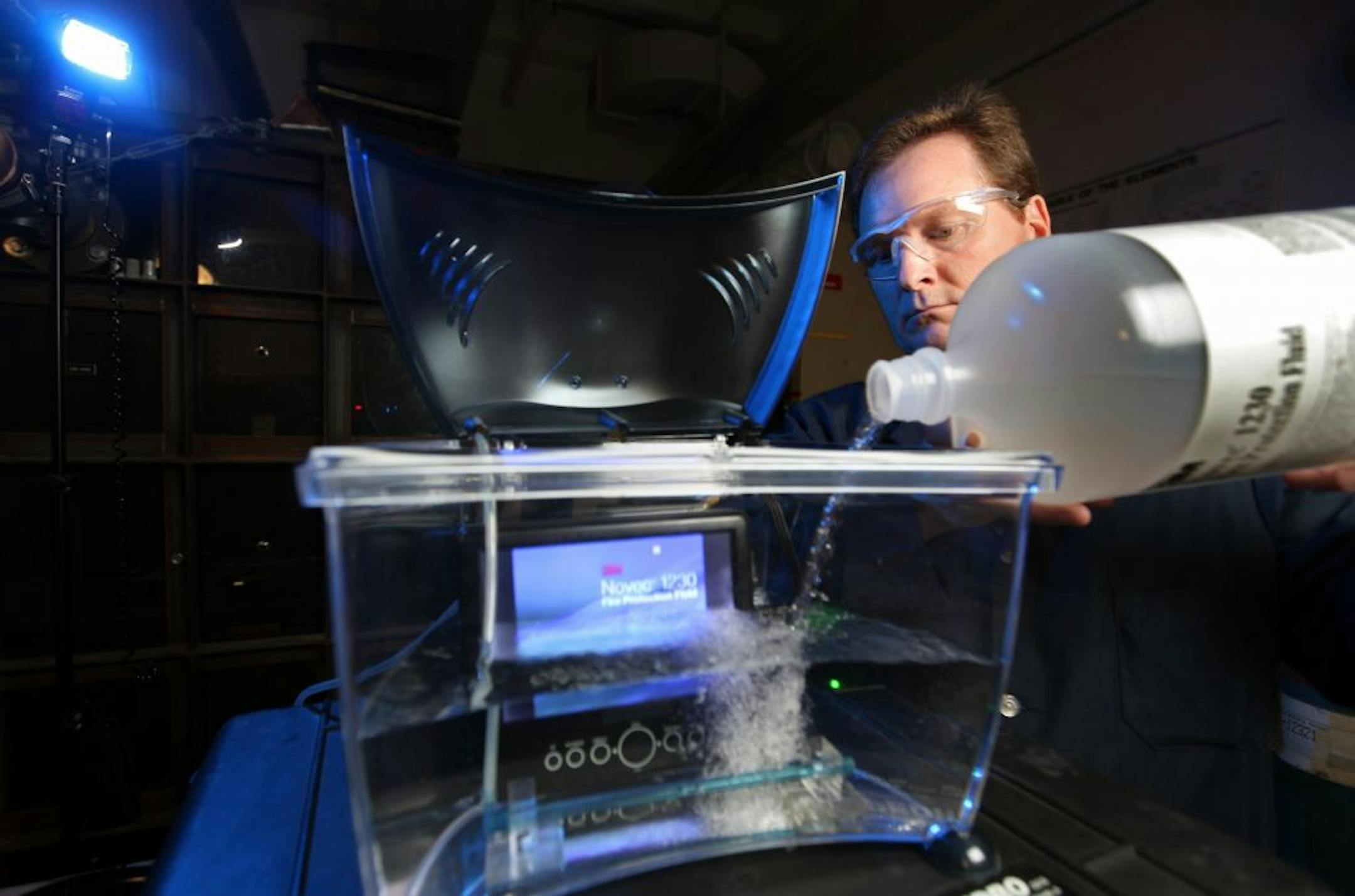 At 3M, lead research specialist John Owens worked with a product he invented: 3M Novec Engineered Fluid HFE-7200. One amazing property of the cleaner and preservative: You can submerge an electronic device in the fluid to clean it. Here Owens poured a Novec solution into a tank with a running LCD screen.