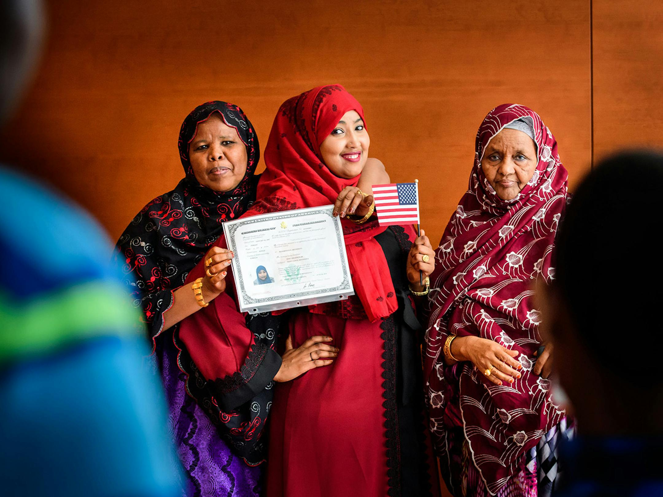 Koss Elmi, center, posed for photos with her mom Bilad Ibrahim, left, and Aunt Habiba Farah, right, after Koss Elmi became a U.S. citizen at the naturalization ceremony.