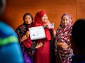 Koss Elmi, center, posed for photos with her mom Bilad Ibrahim, left, and Aunt Habiba Farah, right, after Koss Elmi became a U.S. citizen at the natur