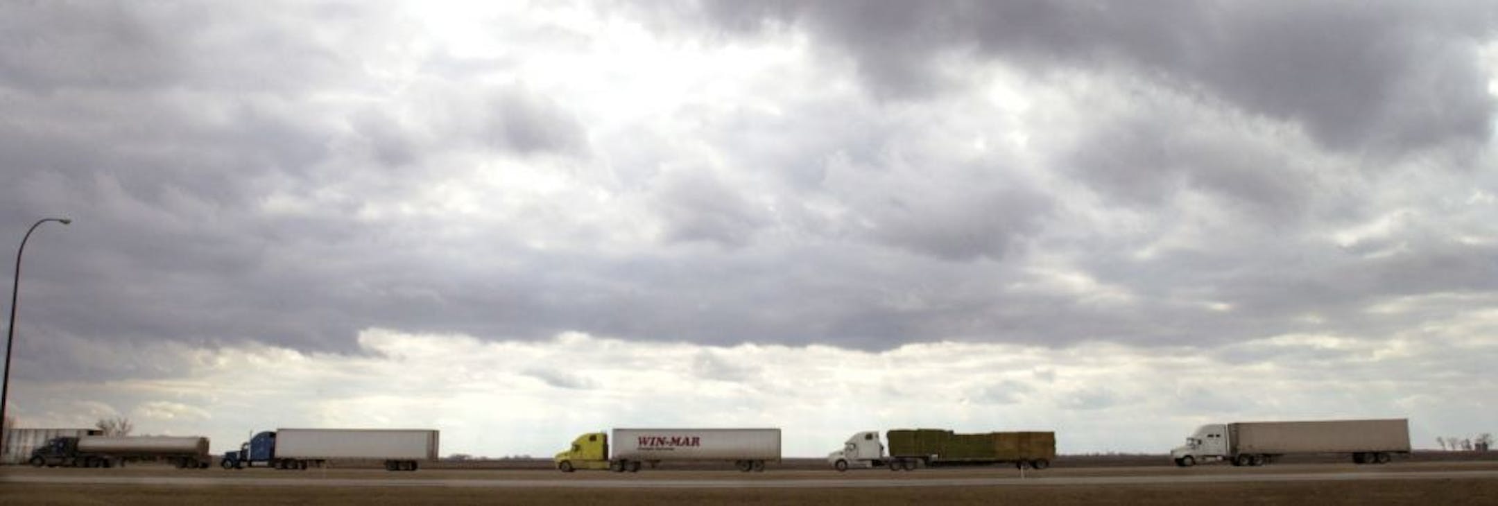 Emerson, Manitoba, Canada, Tues., Mar. 25, 2003--Trucks line up at the Canadian border near Emerson, Manitoba to cross into the United States at Pembina, N.D. For a time there were 60 trucks in line to cross the border. GENERAL INFORMATION: How does the war with Iraq affect the Minnesota-Canadian border.