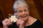 Mary Jo Lindeberg, 82, holds up a cookie marking the date when her original birth records will be unsealed.