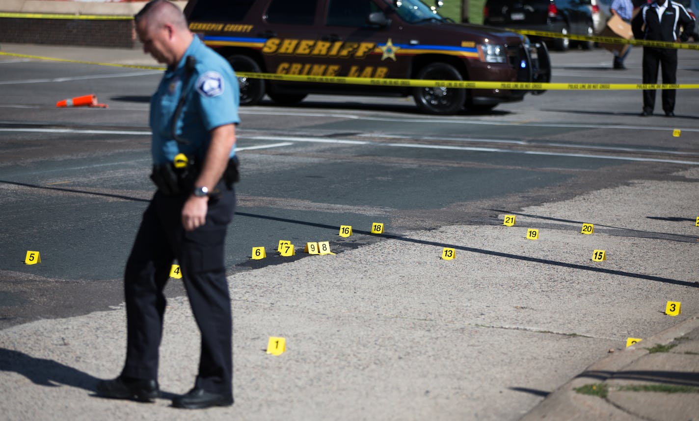 HCMC082714 * Mark Vancleave - mark.vancleave@startribune.com * Minneapolis police investigated shots that were fired at Hennepin County Medical Center in downtown Minneapolis on Tuesday, Aug. 26, 2014. [Dozens of shell casings littered South 8th Street.]