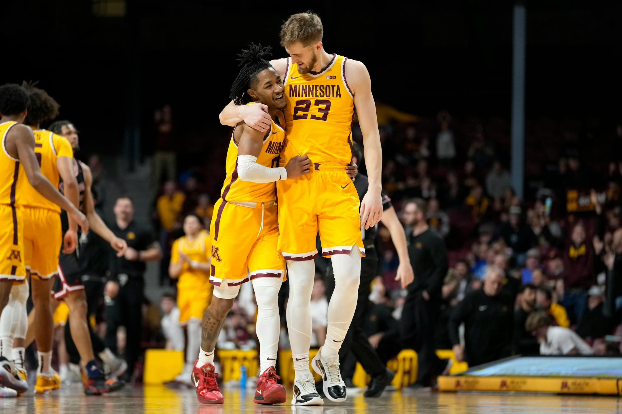 Minnesota guard Elijah Hawkins, left, and forward Parker Fox (23) celebrate after a basket scored by teammate forward Isaiah Ihnen during the second half of an NCAA college basketball game against IUPUI, Tuesday, Dec. 12, 2023, in Minneapolis. (AP Photo/Abbie Parr)