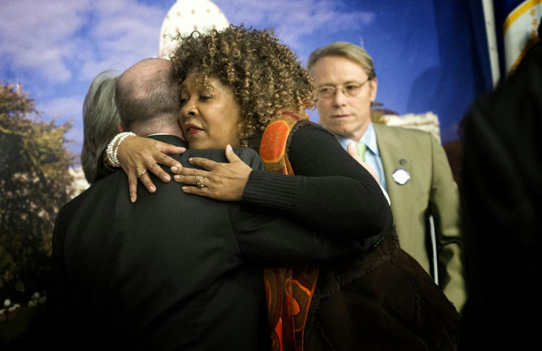 Rose McGee, who is fighting to keep her foreclosed home, hugged Rep. Mike Freiberg, who has sponsored legislation that would bar some foreclosure practices.