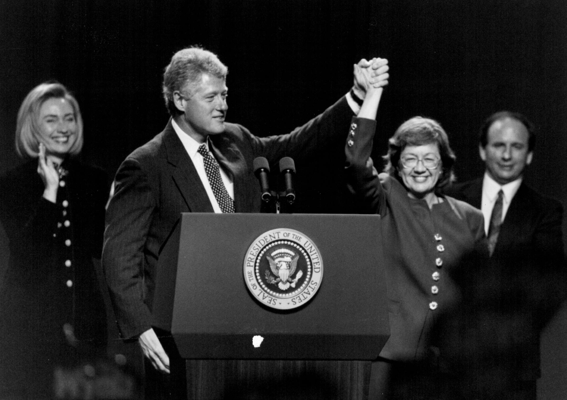 November 7, 1994: President Bill Clinton holds up Ann Wynia's hand with Hillary Clinton to the left and Sen Paul Wellstone on the right.