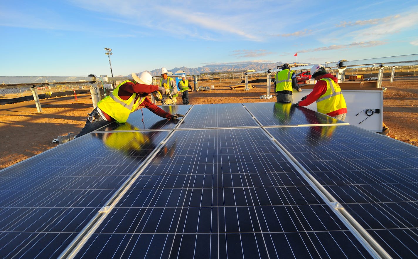 Workers for Mortenson Contruction, based in Golden Valley, install solar panels at the Tech Park Solar Facility at the University of Arizona in Tuscon. The company, which also is a leading wind farm contractor, has been expanding into solar power since 2008. It sees more opportunity in its home state now that the Minnesota Legislature has passed a solar standard requiring major electric utilities to get 1.5 percent of the power from the sun by the end of 2020.