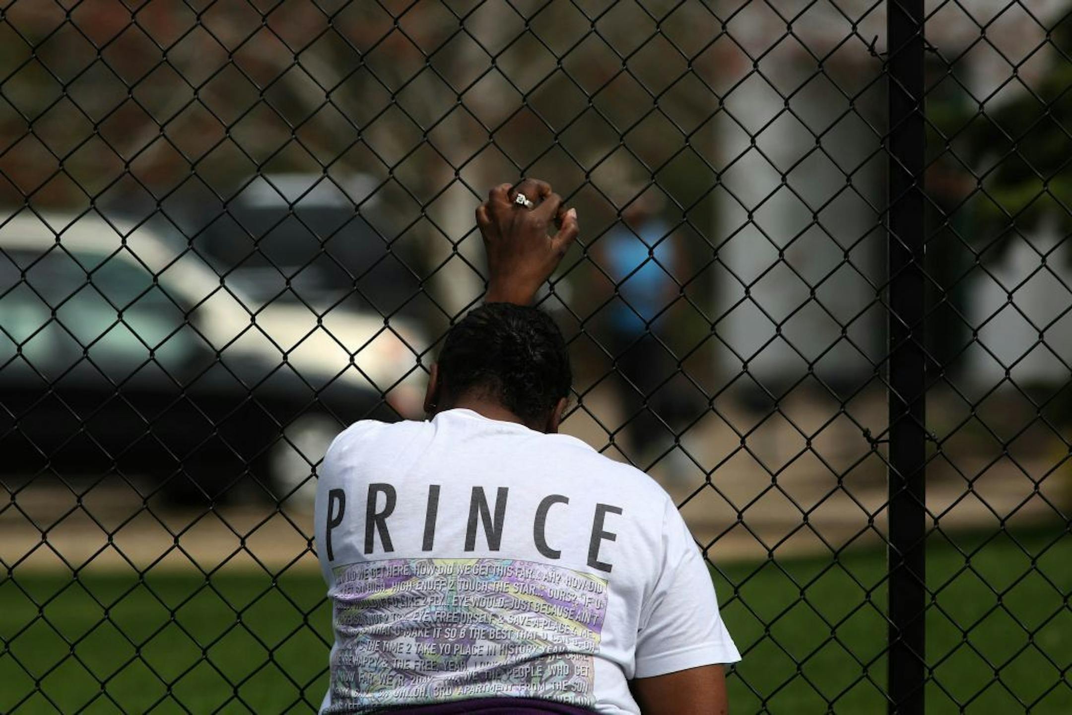 A woman wept as she grabbed a fence outside Paisley Park, where Prince was found dead on Thursday.