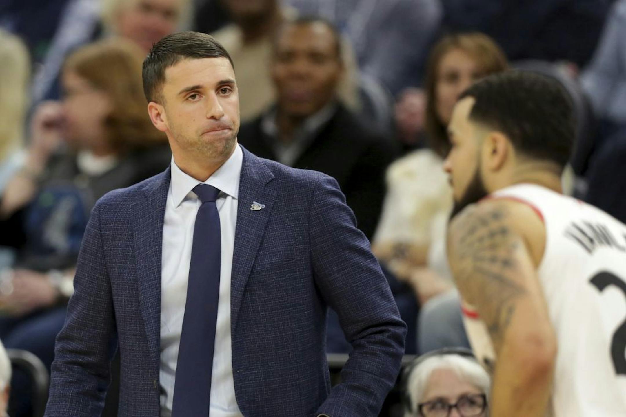 Minnesota Timberwolves head coach Ryan Saunders, left, watches Toronto Raptors guard Fred VanVLeet after VanVleet hit a three-point basket in the fourth quarter of an NBA basketball game Saturday, Jan. 18, 2020, in Minneapolis.