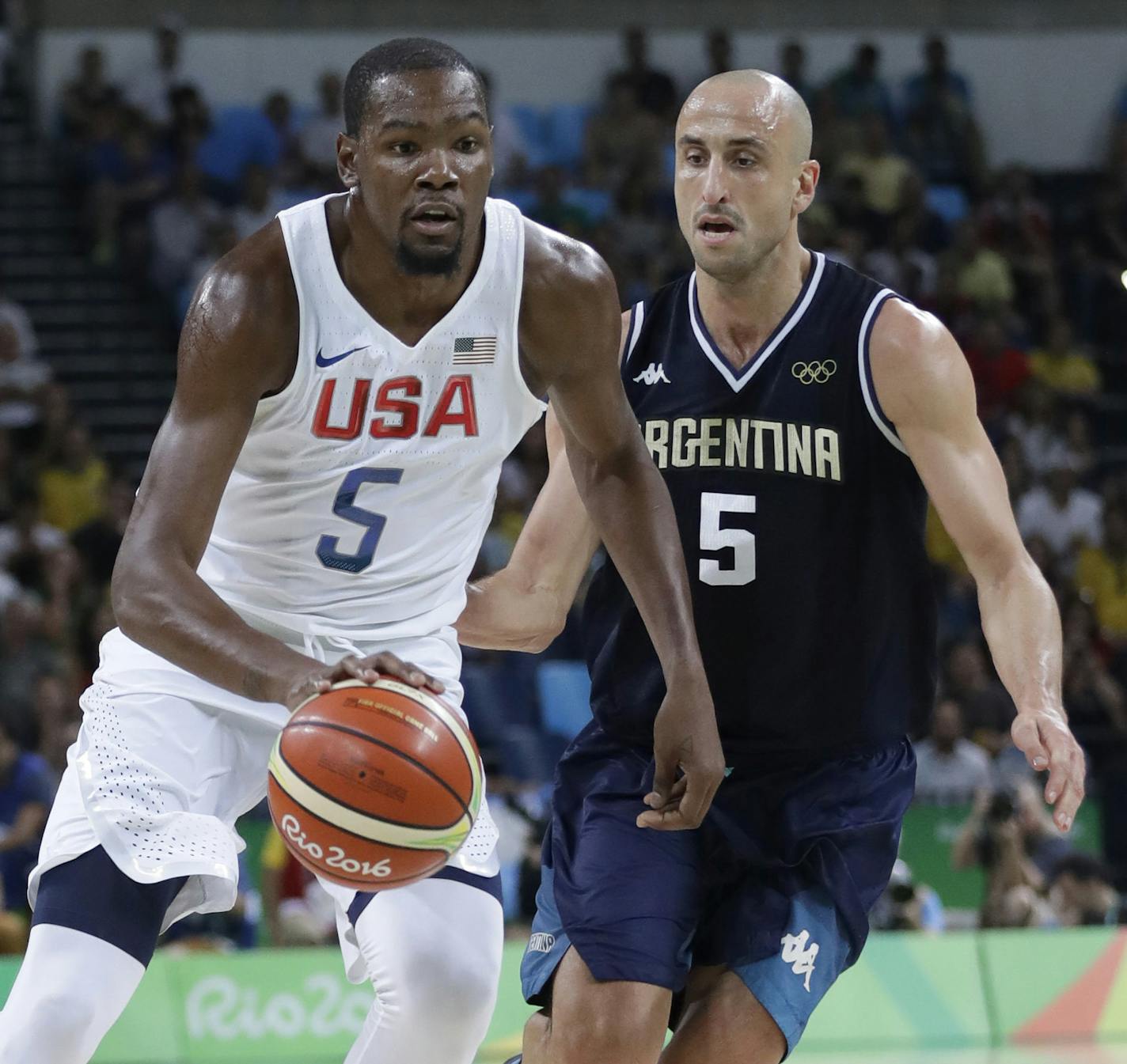 United States' Kevin Durant, left, drives around Argentina's Manu Ginobili, right, during a men's quarterfinal round basketball game at the 2016 Summer Olympics in Rio de Janeiro, Brazil, Wednesday, Aug. 17, 2016. (AP Photo/Eric Gay)