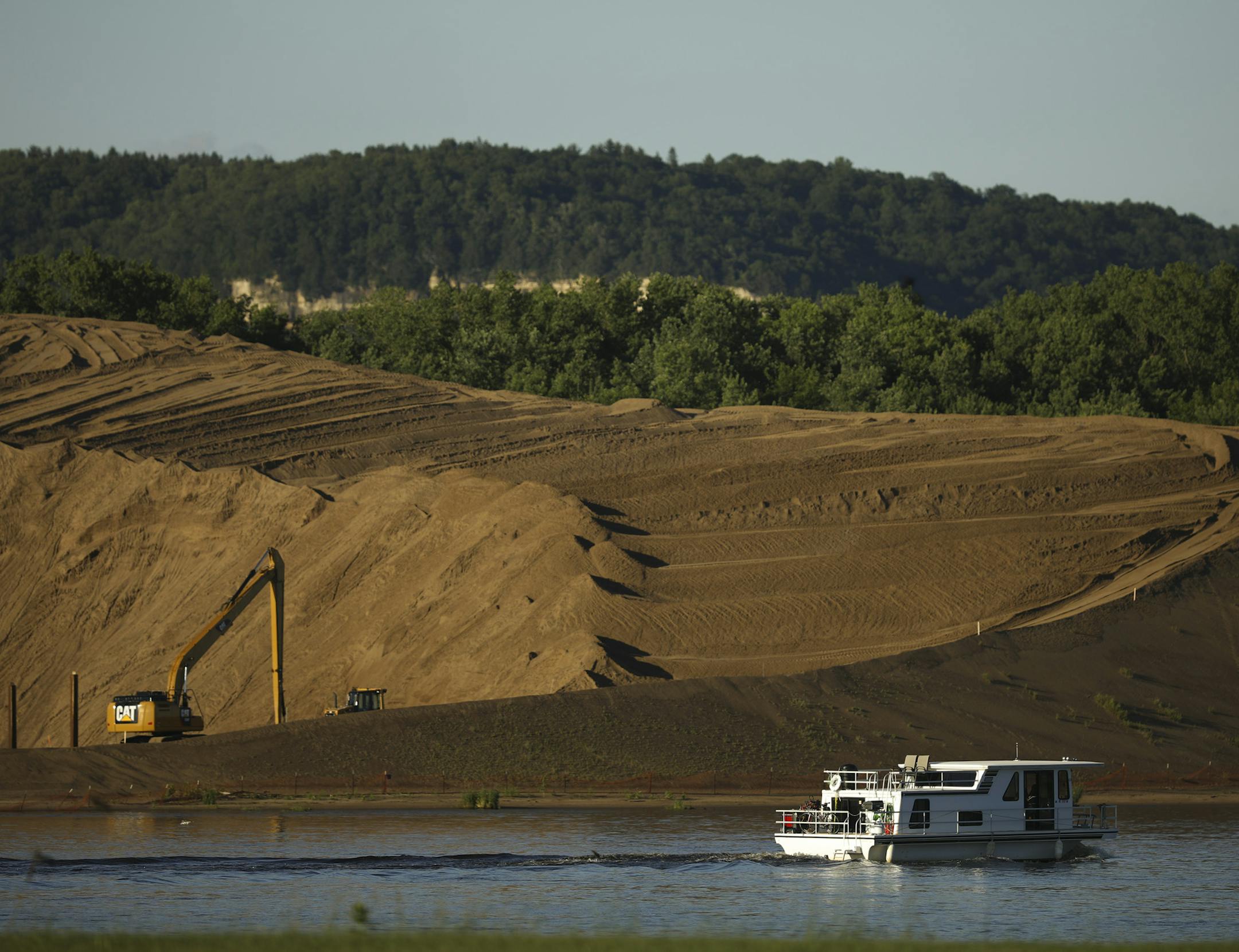 Sand dredged from the Mississippi River is piled high on the river bank near Wabasha. The city and the Army Corps of Engineers have reached an agreement to minimize the impact of dredging on the city. ORG XMIT: MIN1706211352521745