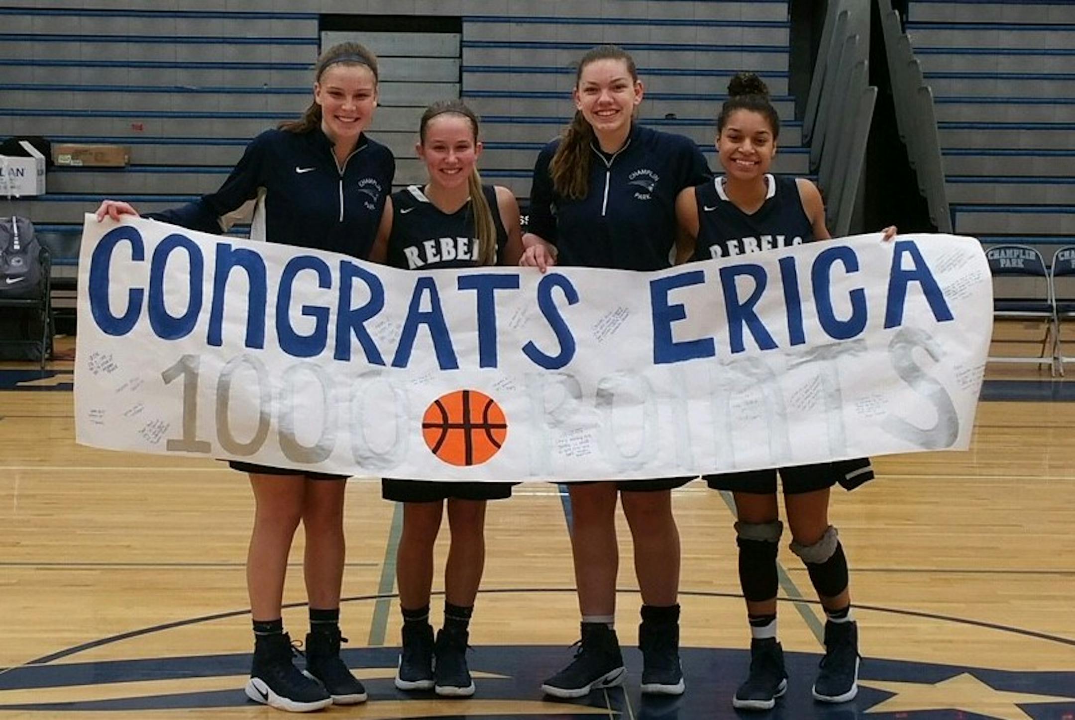 A core group of four seniors who have played together since fourth grade. (L to R): Megan Munneke, Erica Hicks, Gabby Mocchi and Amanda Pollard celebrating after game where Hicks scored her 1,000th career point against Coon Rapids on Jan. 27, 2017. Photo credit: Jeff Munneke