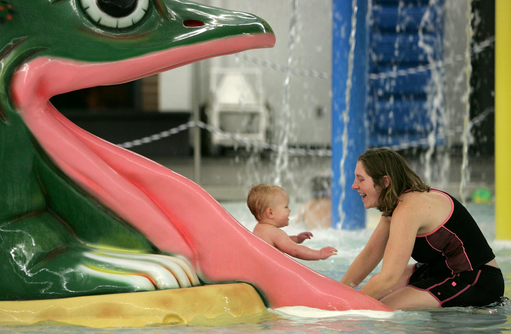 East Bethel resident Shannon Wong, right, watched after 16-month-old Liam Schilling as he slid down a slide into the water at the Andover YWCA pool. Wong, a mother of four, was at the pool with her own children and her friend Tina Schilling, who is Liam's mother.