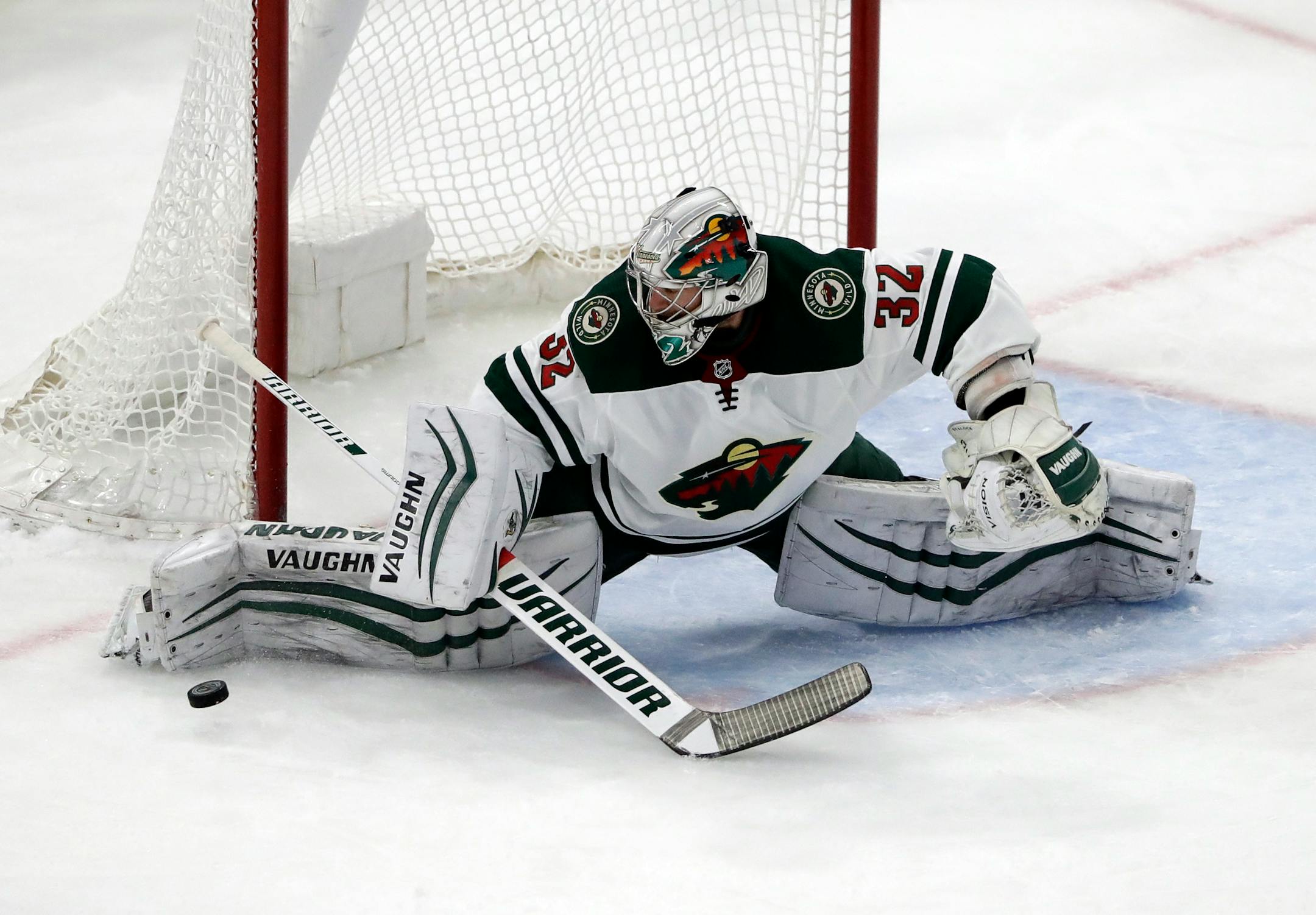 Minnesota Wild goalie Alex Stalock blocks a shot against the Chicago Blackhawks during the first period of an NHL hockey game, Sunday, Dec. 17, 2017, in Chicago. (AP Photo/Nam Y. Huh)