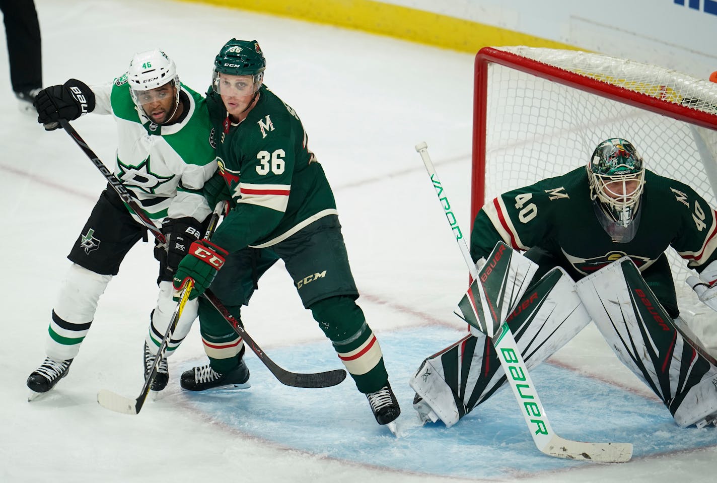 Wild defenseman Nick Seeler and Stars center Gemel Smith tangled in front of Minnesota goaltender Devan Dubnyk