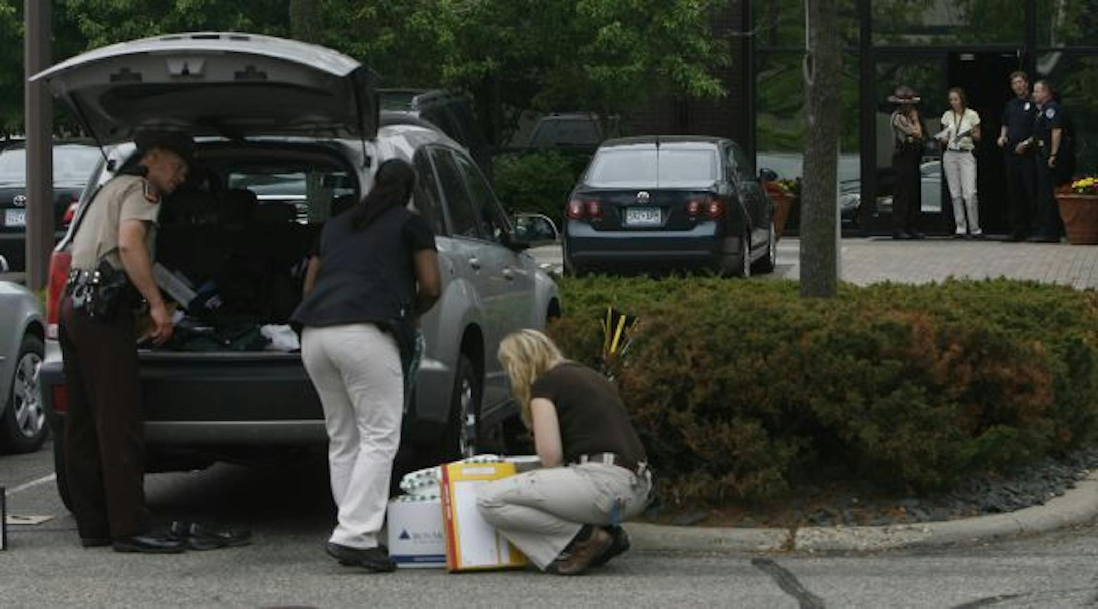 Investigators collected evidence Wednesday at the Denny Hecker Automotive Group's corporate headquarters in St. Louis Park. Hecker customers have complained that car titles were not delivered and payments were not made as promised.