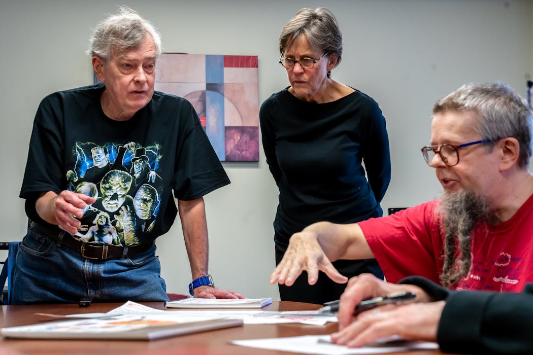 Byron (left) and Brian discuss drawings with their art teacher, Lynda Monick-Isenberg