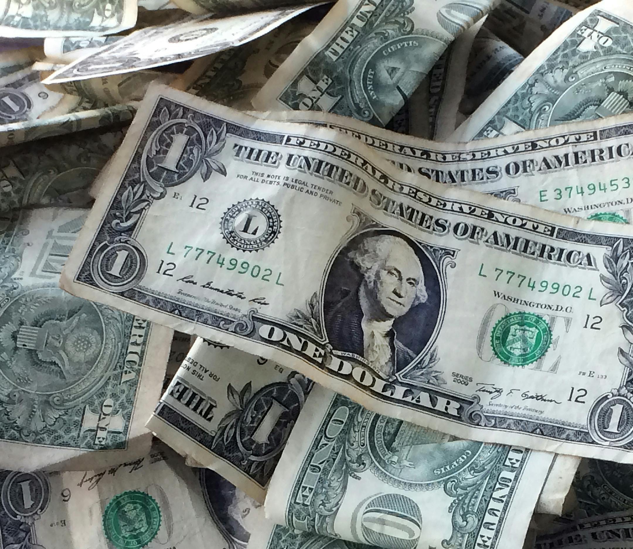 FILE - This Oct. 24, 2016 file photo shows dollar bills in New York. Yes, money matters are personal, but don’t be embarrassed or reticent. The more details you give, including dreams, regrets and mistakes, the more a financial planner can do to help you reach your financial goals. (AP Photo/Mark Lennihan, File)