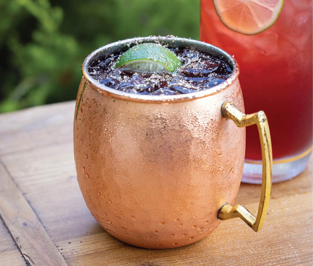 Holly Jolly cocktail can be served in a mule mug or Collins glass. From “Every Cocktail Has a Twist,” by Carey Jones and John McCarthy.