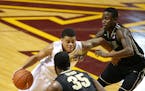 Minnesota's Nate Mason (2) is double teamed by Purdue's Jon Octeus, right, and Raheal Davis (35) during the first half Saturday, Feb. 7, 2015, at Will