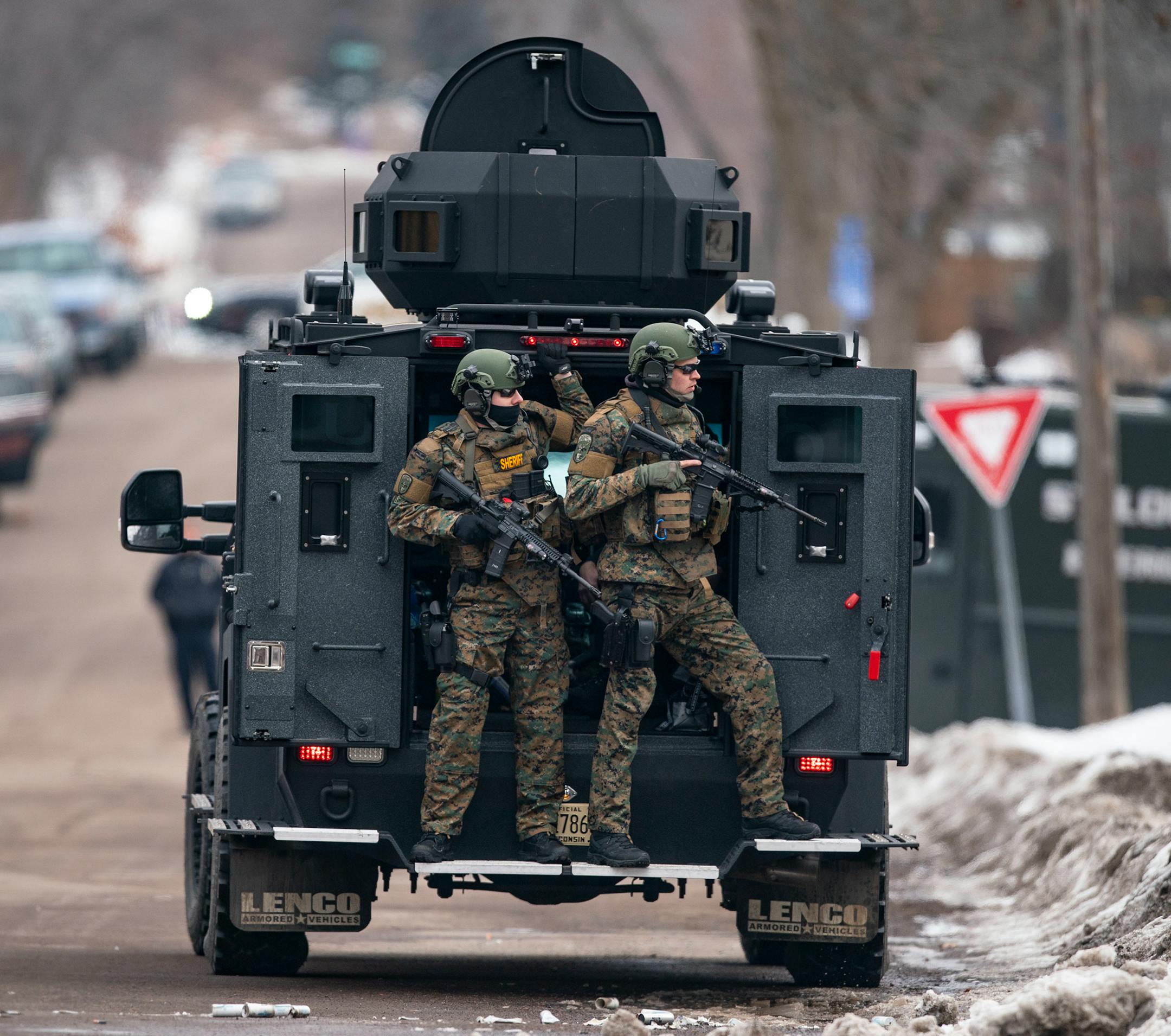 St. Louis County sheriffs were armed with rifles and grenade launchers as they maintained a perimeter and attempted to force the gunman out of his house.
