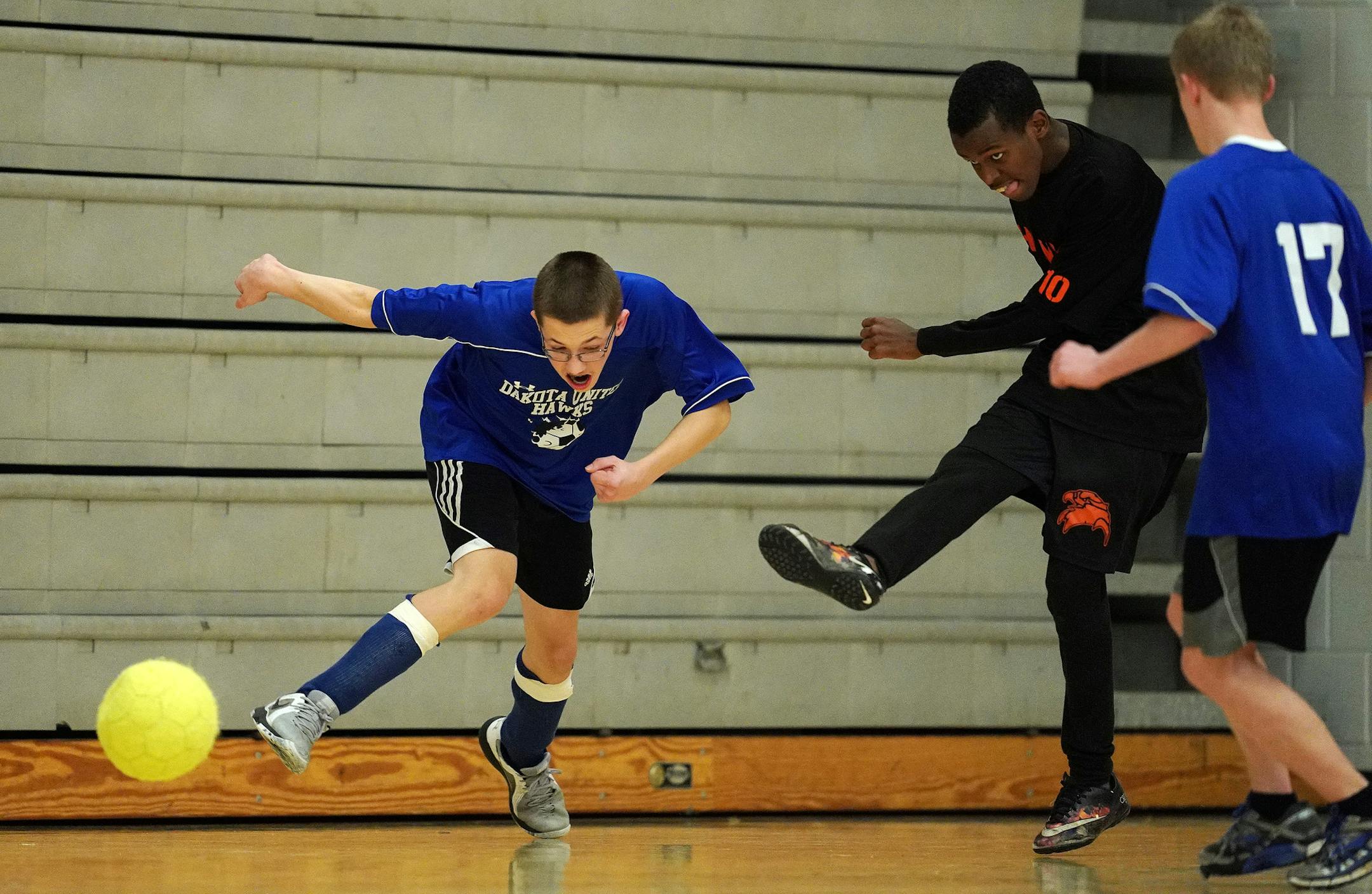 St. Paul Humboldt Liban Farah (10) kicked the ball past Dakota United forward Cooper Wilson (14) and Dakota United forward Samuel Gerten (17) in the first half. ] ANTHONY SOUFFLE ï anthony.souffle@startribune.com Dakota United High School played St. Paul Humboldt High School in the adapted soccer physically impaired division championship game Saturday, Nov. 17, 2018 at Stillwater High School in Stillwater, Minn.