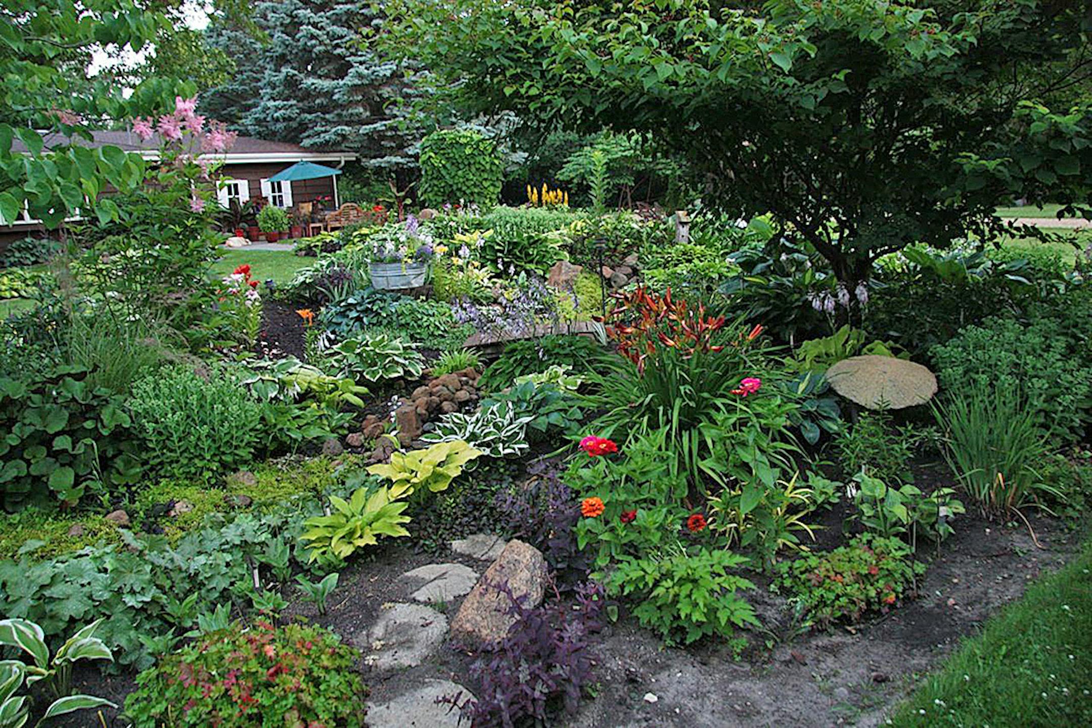 Mike and Kathy Pedersen's Shakopee gardens are an oasis of colorful perennials and hosta bordering a stream and pond. Provided