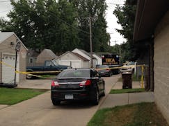 The area behind a South St. Paul home was taped off as police investigated a woman's death.